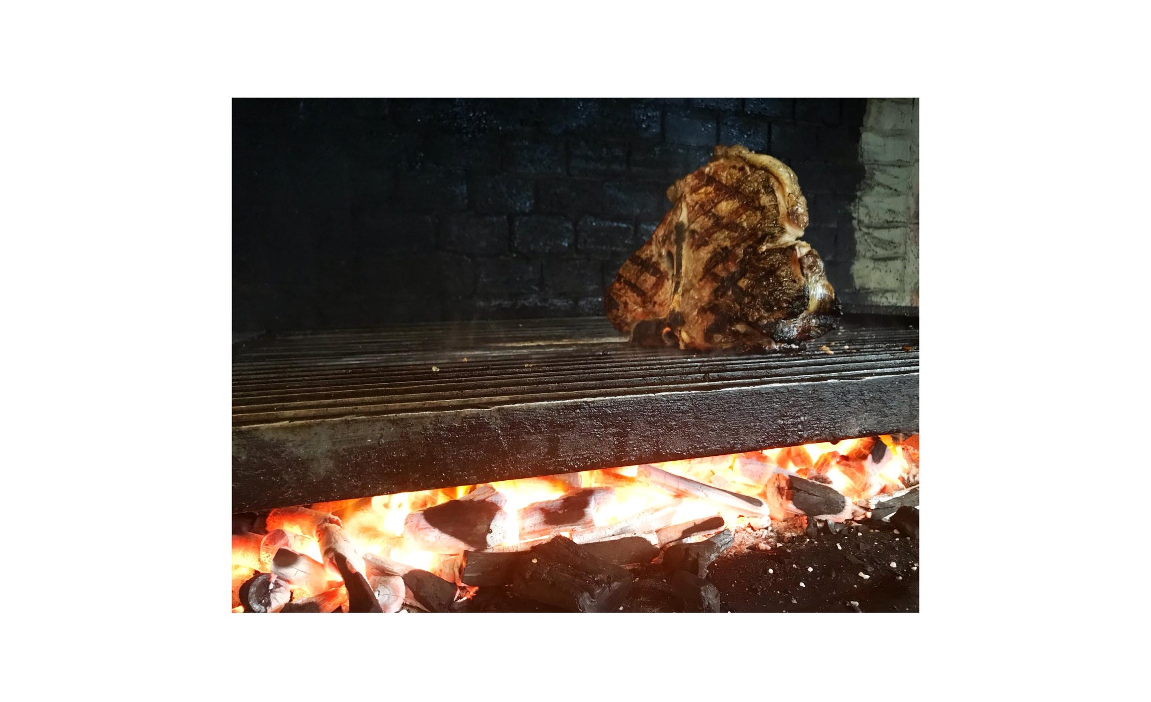 How is a wood-fired grill prepared?